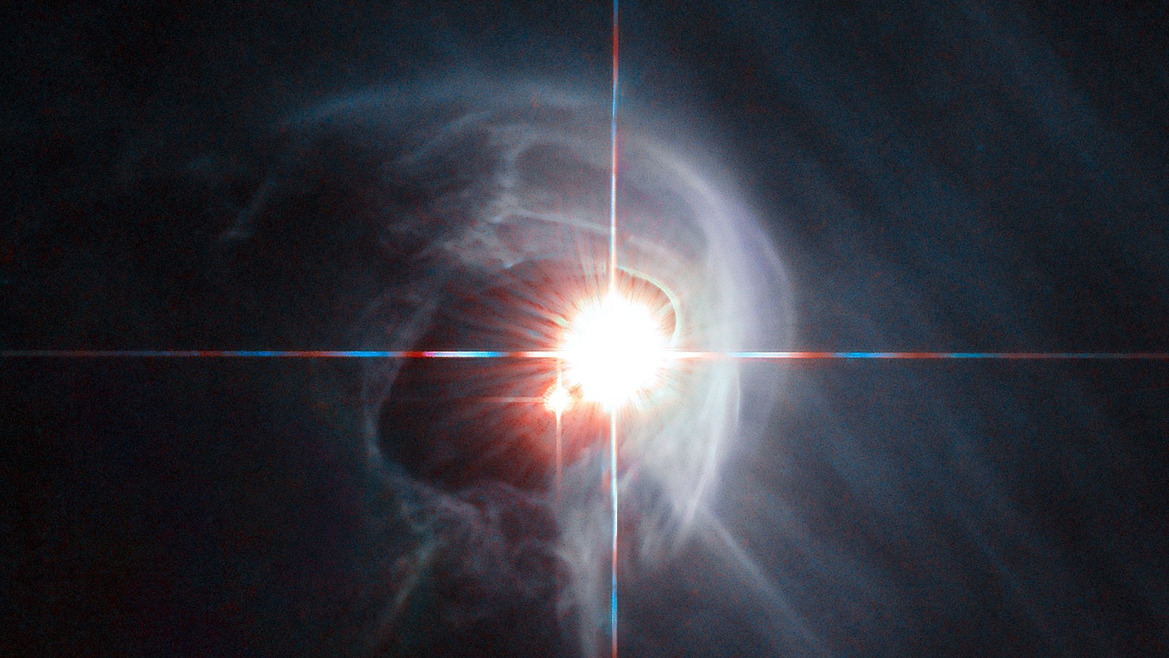 Two stars blazing within a wispy gas cloud in space