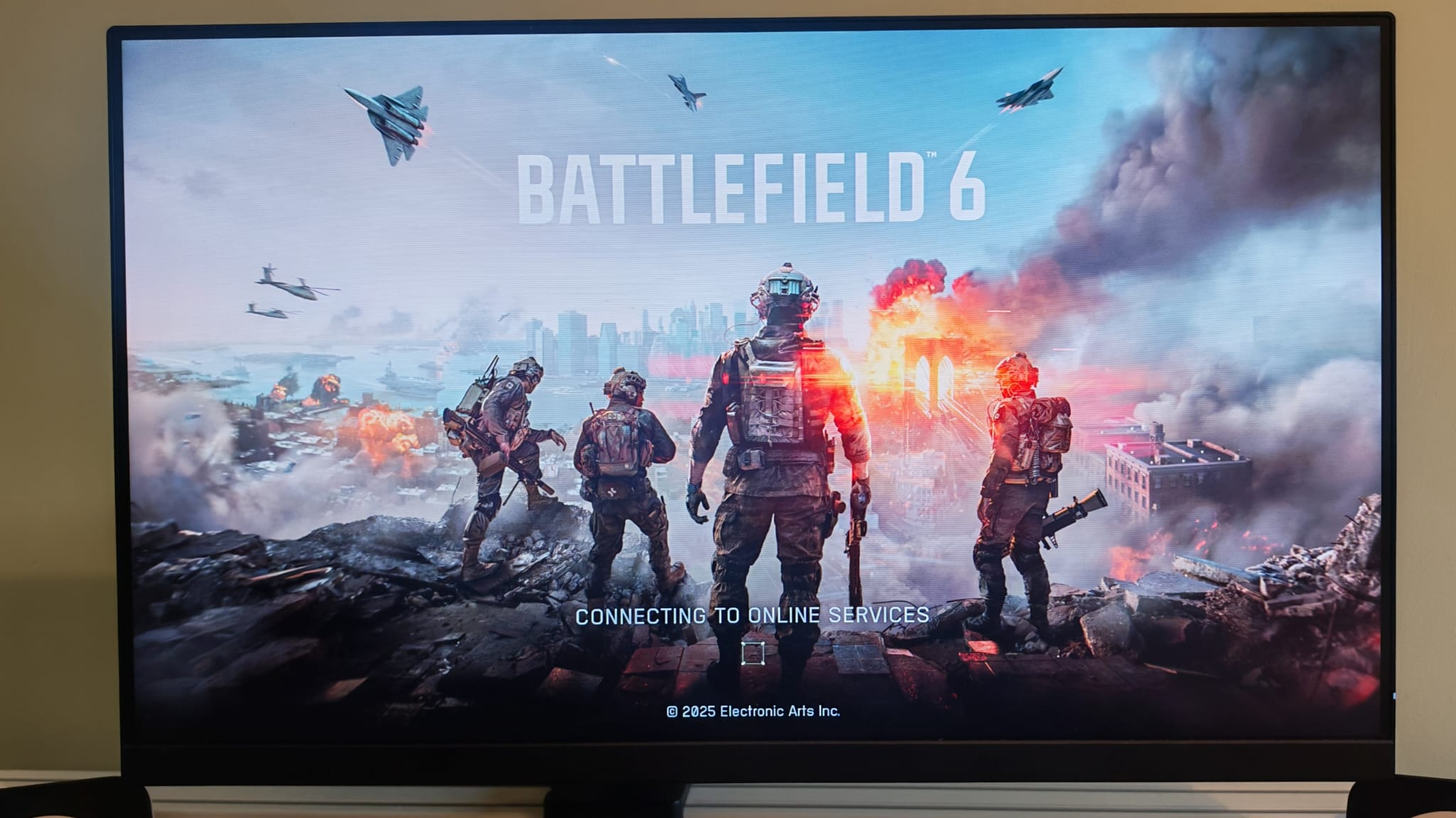 A picture of Battlefield 6's loading screen on a monitor
