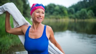 Woman towelling off after outdoor swim