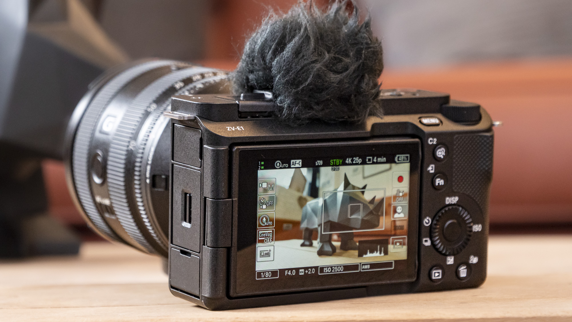 The Sony ZV-E1 camera sitting on a wooden table
