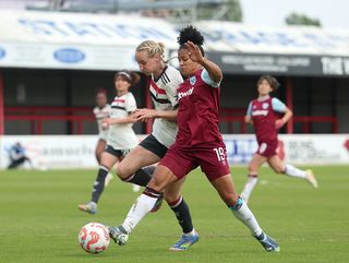 Shekiera Martinez of West Ham United in action against Millie Turner of Manchester United during Barclays Women's Super League match between West Ham United and Manchester United at Chigwell Construction Stadium on April 19, 2025 in Dagenham, England.