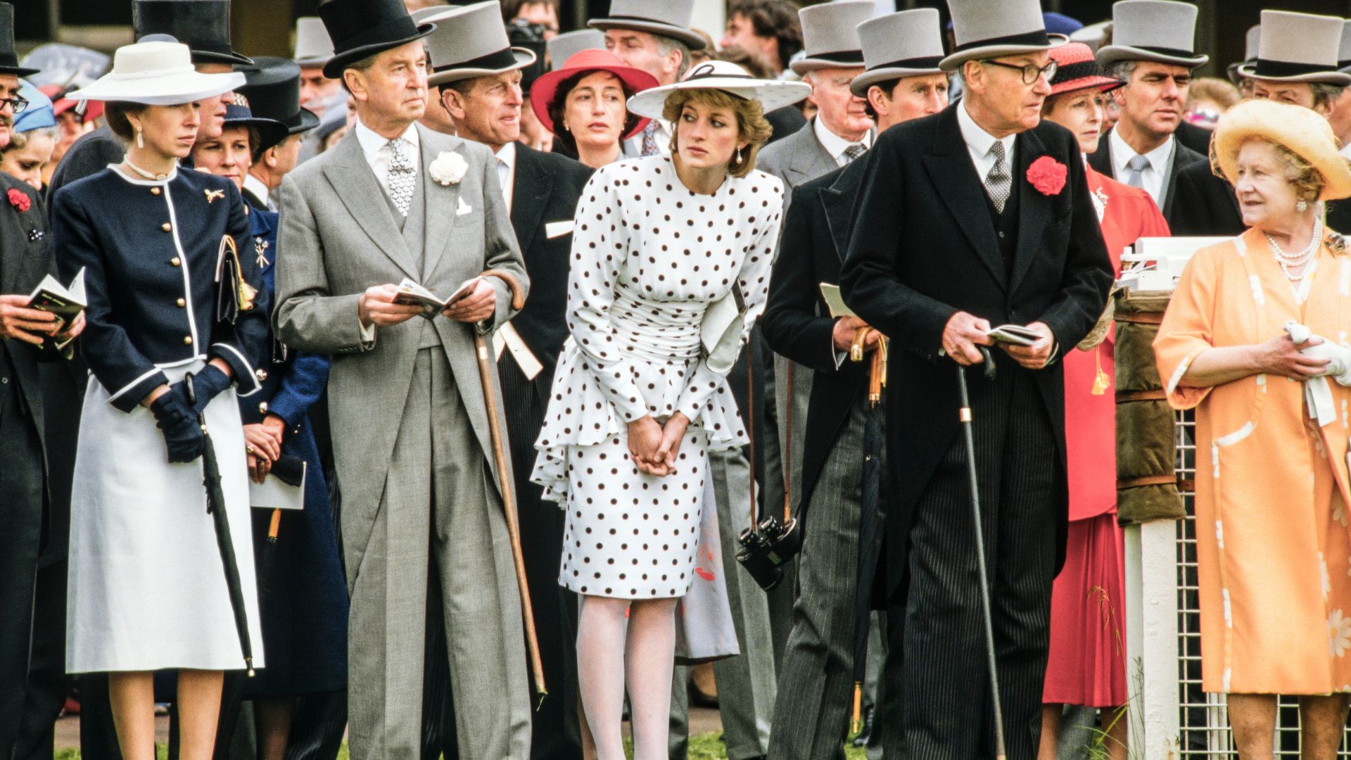 Princess Diana wears a white polka dot dress.