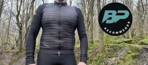 Man wearing a cycling jacket standing in a wood