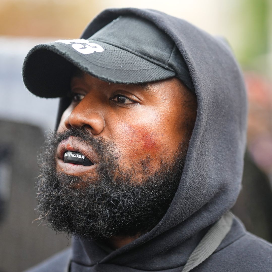 Ye West wearing a black cap and gum shield at Paris Fashion Week