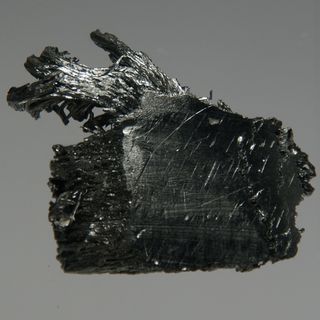 Ultrapure crystalline thulium, 22.3 grams. This piece is 2.5 by 3 centimeters.