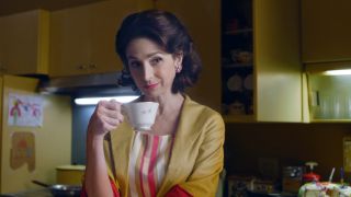 Marin Hinkle as Rose holding a tea cup in The Marvelous Mrs. Maisel