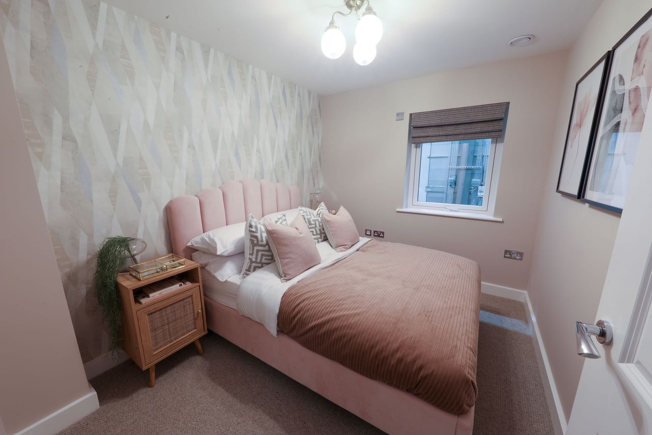 A pink bed inside a bedroom inside the newbuild home