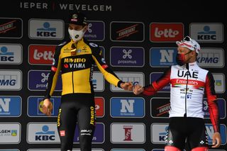 WEVELGEM BELGIUM MARCH 28 Podium Wout Van Aert of Belgium and Team Jumbo Visma Matteo Trentin of Italy and UAE Team Emirates Celebration during the 83rd GentWevelgem in Flanders Fields 2021 Mens Elite a 254km race from Ypres to Wevelgem Celebration Social distancing Mask Covid Safety Measures GWE21 GWEmen FlandersClassic on March 28 2021 in Wevelgem Belgium Photo by Tim de WaeleGetty Images