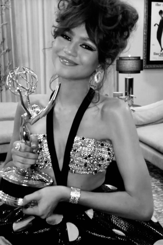 Zendaya accepts Emmy Award wearing Armani Privé and Bulgari.
