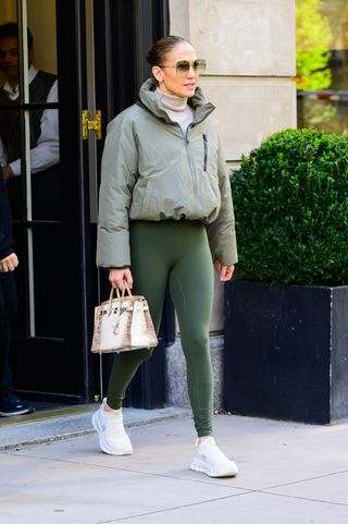 Jennifer Lopez leaves her apartment in green leggings and the chunky sneakers trend