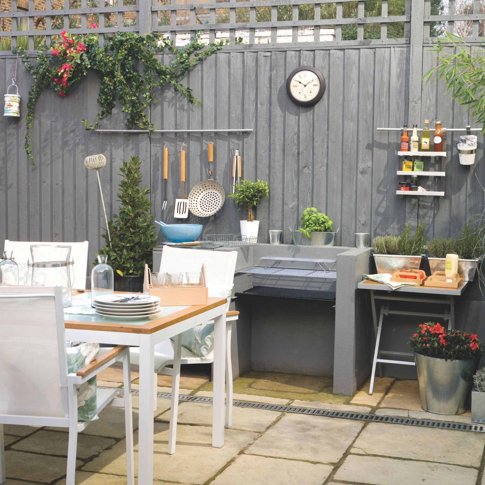 A garden patio seating nook with outdoor dining set and storage