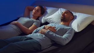 A couple sleeping with the Eight Sleep Pod 4 mattress cover