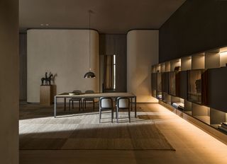 Dining room featuring Jasper Morrison's chair for Molteni with a curved back and black wood structure