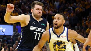 Stephen Curry #30 of the Golden State Warriors drives to the basket against Luka Doncic #77 of the Dallas Mavericks