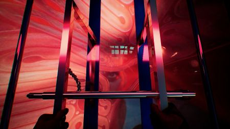 In first person, a hand grabs onto a set of prison bars against a fleshy pink backdrop