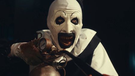 Art the Clown smiling wild holding flamethrower in Terrifier 3