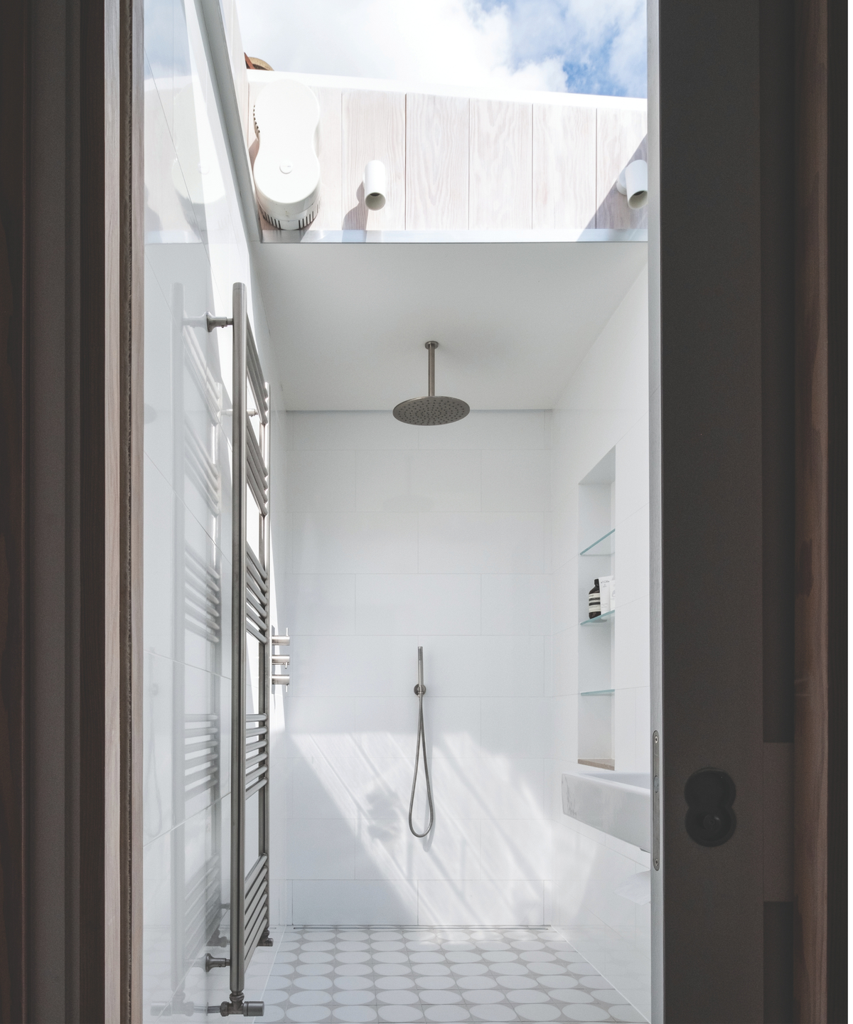 Shower with tiled flooring and open roof