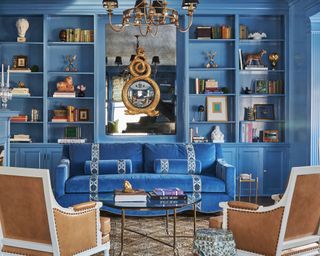 living room with blue walls, cabinetry and sofa with traditional decor