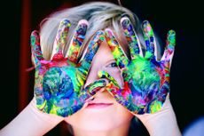 Image of child with paint on both hands
