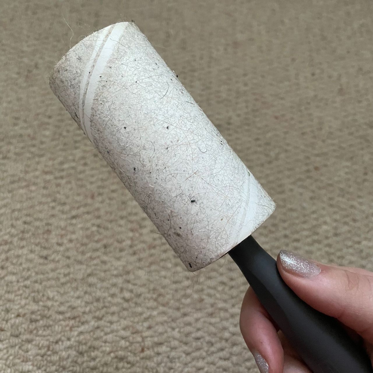 Dirty lint roller covered in dust and hair