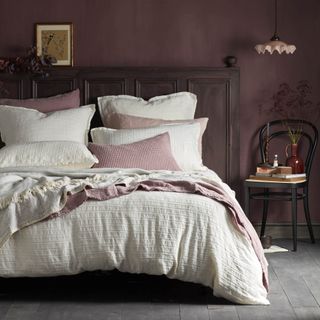 Purple bedroom with wooden bed