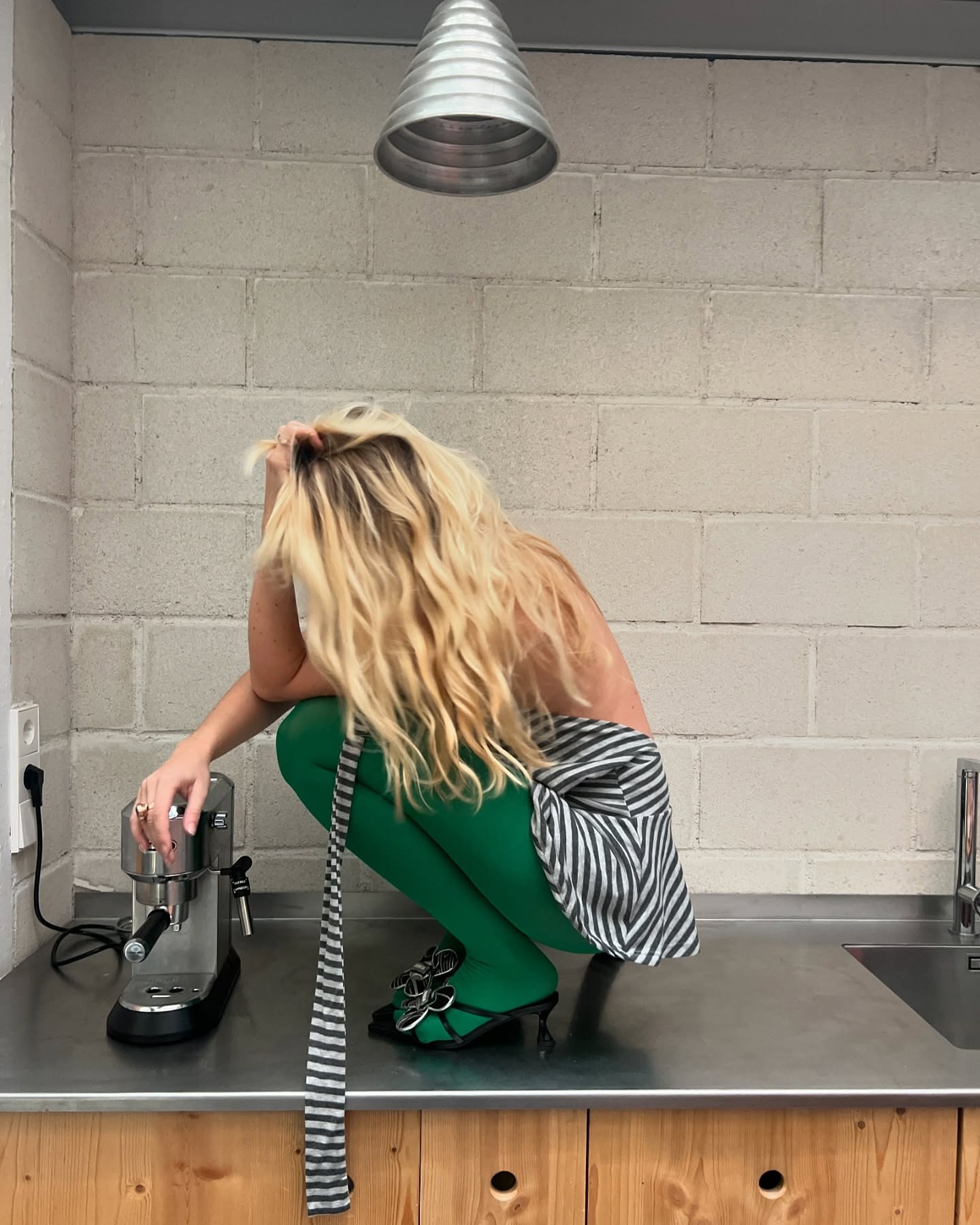 A woman squatting on a table.