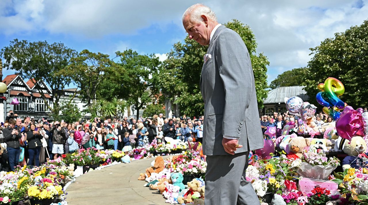 King Charles III views tributes outside Southport Town Hall, during his visit to meet with members of the local community, following the July 29 attack at a children&#039;s&#039; dance party on August 20, 2024 in Southport, England.