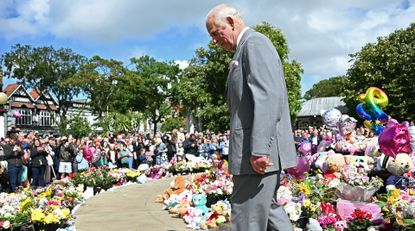 King Charles III views tributes outside Southport Town Hall, during his visit to meet with members of the local community, following the July 29 attack at a children&#039;s&#039; dance party on August 20, 2024 in Southport, England.