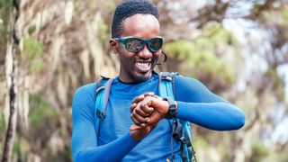 Trail runner checking GPS sports watch