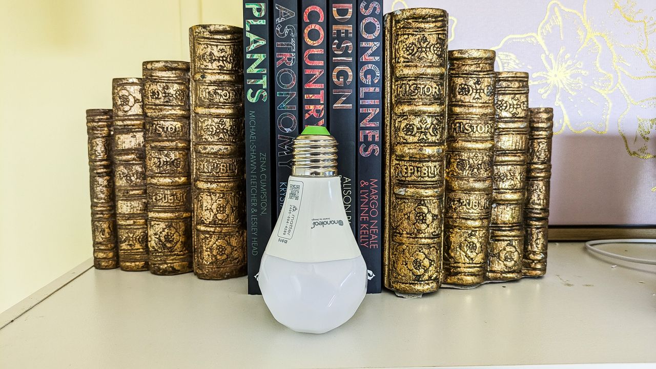 Nanoleaf Essentials smart bulb unplugged and standing on a desk