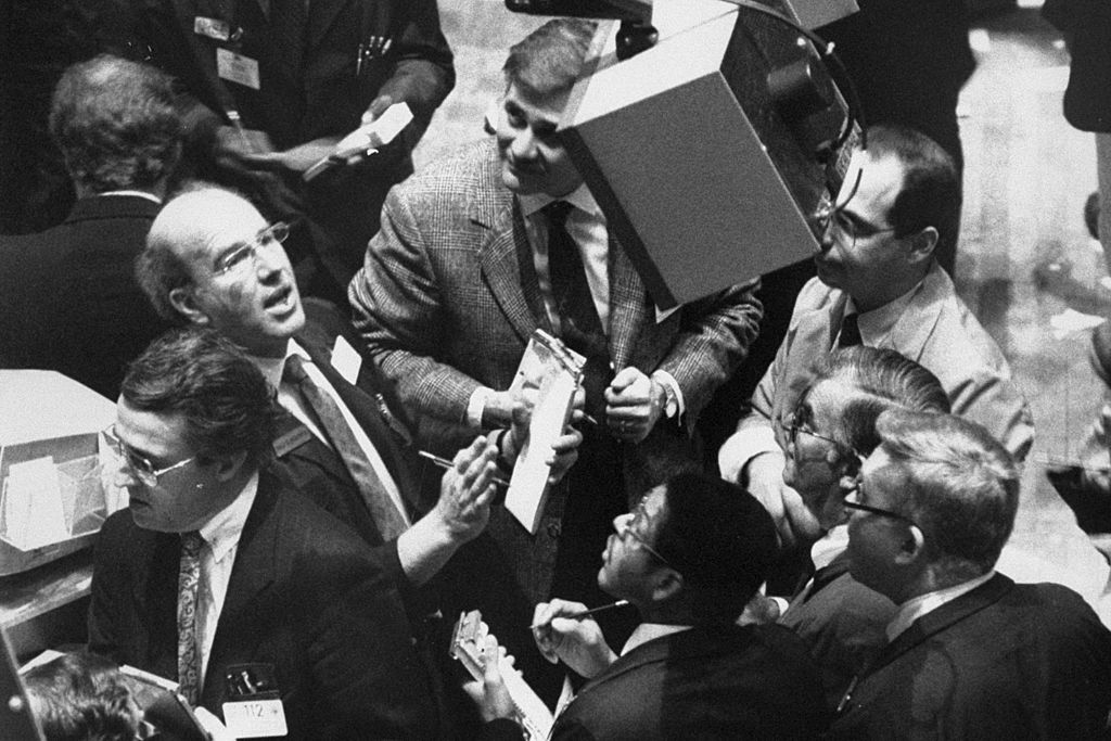 Traders look at numbers on screen on Black Monday at the Stock Exchange when dow plunged 508 points, Manhattan.