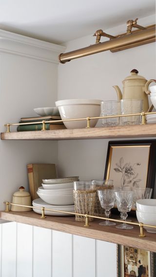 Kitchen shelves with a brass riser rail