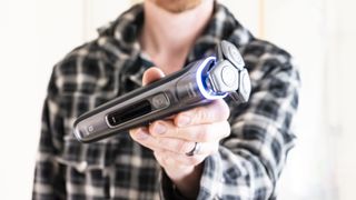 Philips i9000 electric razor in user's hand