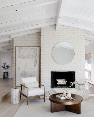 A whitewashed interior with a wood-clad ceiling