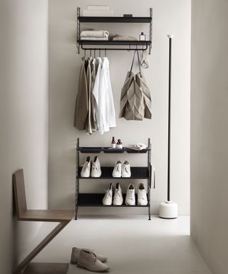 Small hallway with modular storage on one wall for shoes, coats and bags