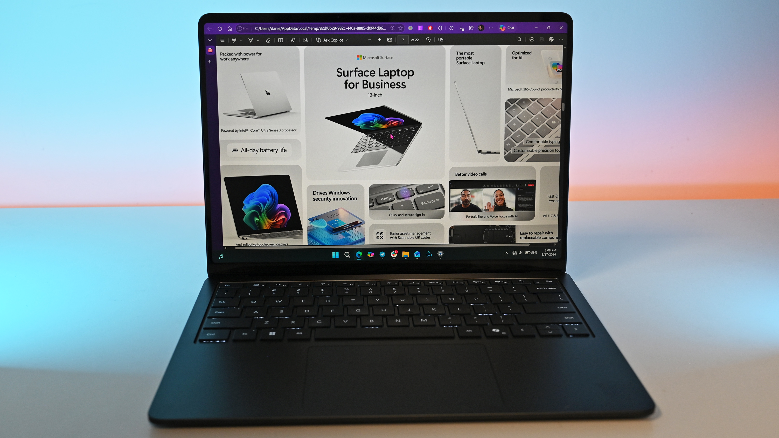A sleek laptop with a black keyboard and a modern design, displaying a blue abstract swirl on its screen, set against a light gradient background.