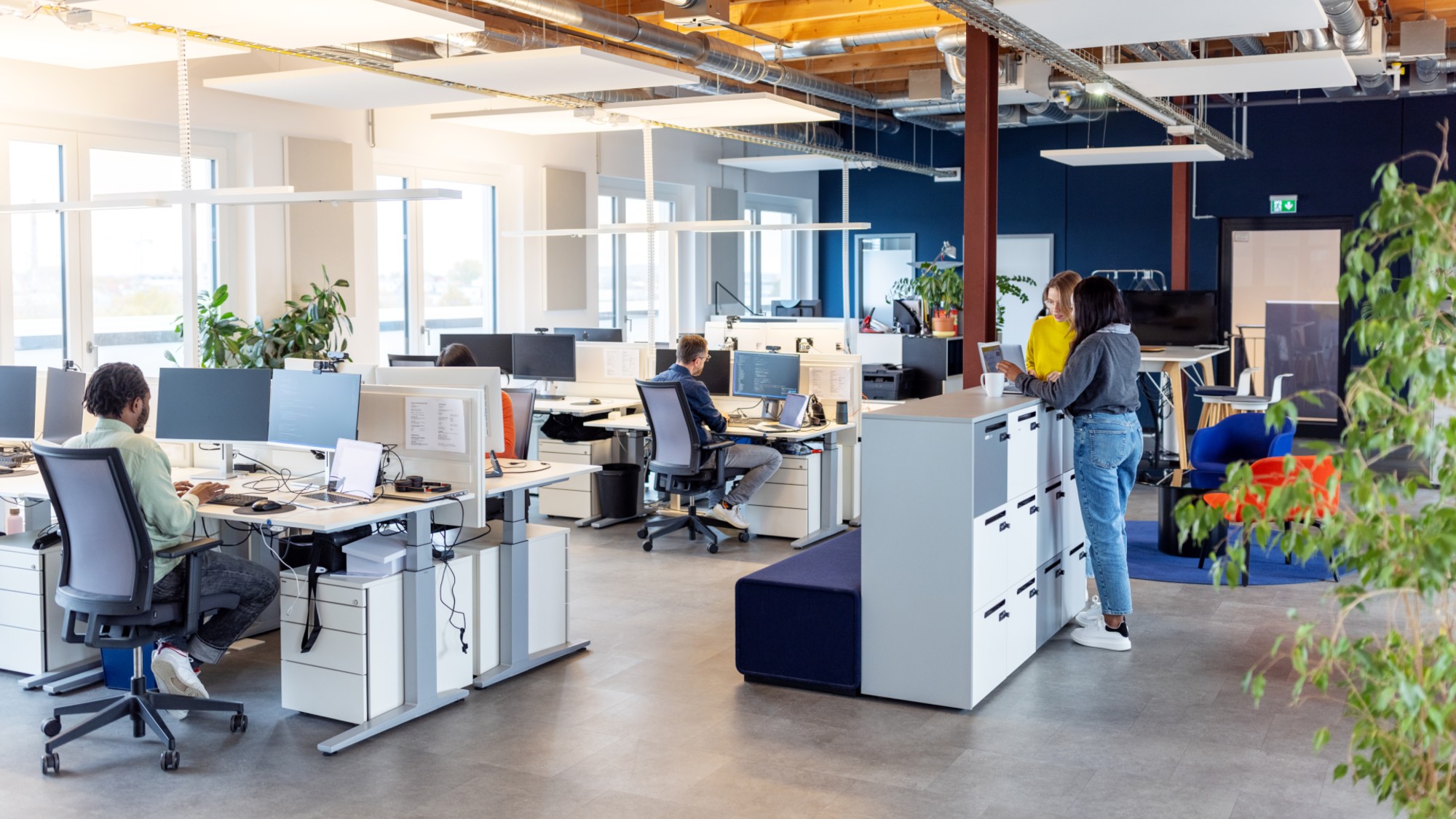 A stock photo of people working in an open-plan office. 
