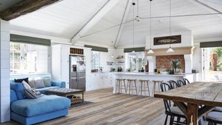 white open plan kitchen with vaulted ceiling and seating and dining areas