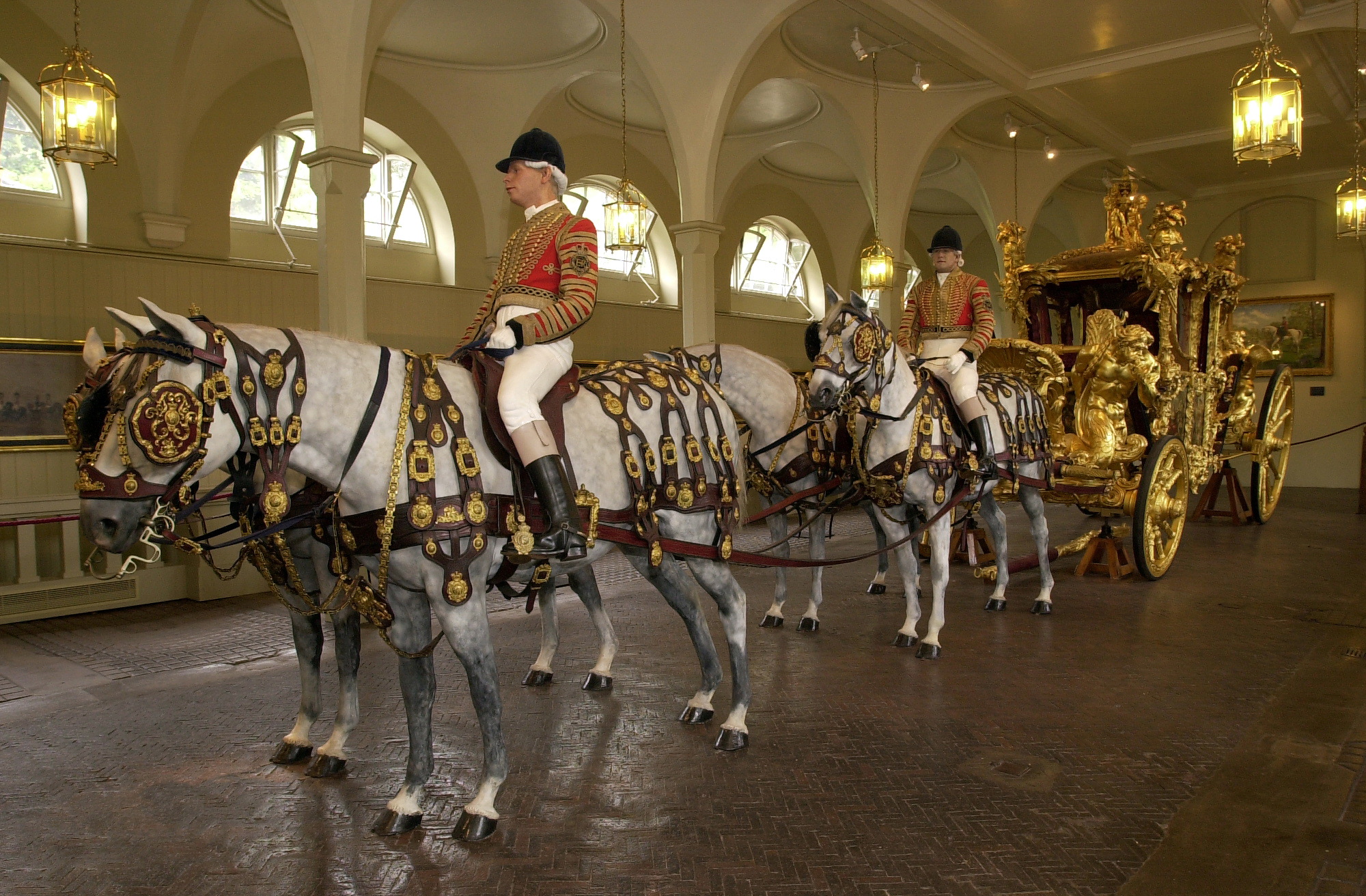 Horsemen and the Gold State Coach photographed within the Royals Mews