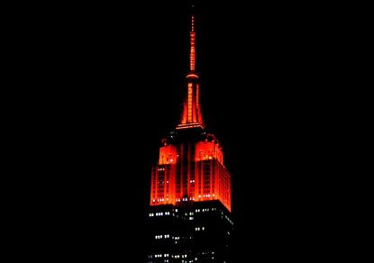 The Empire State Building glows red.