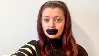 Sleep Features Editor Lauren wearing black mouth tape looking at the camera