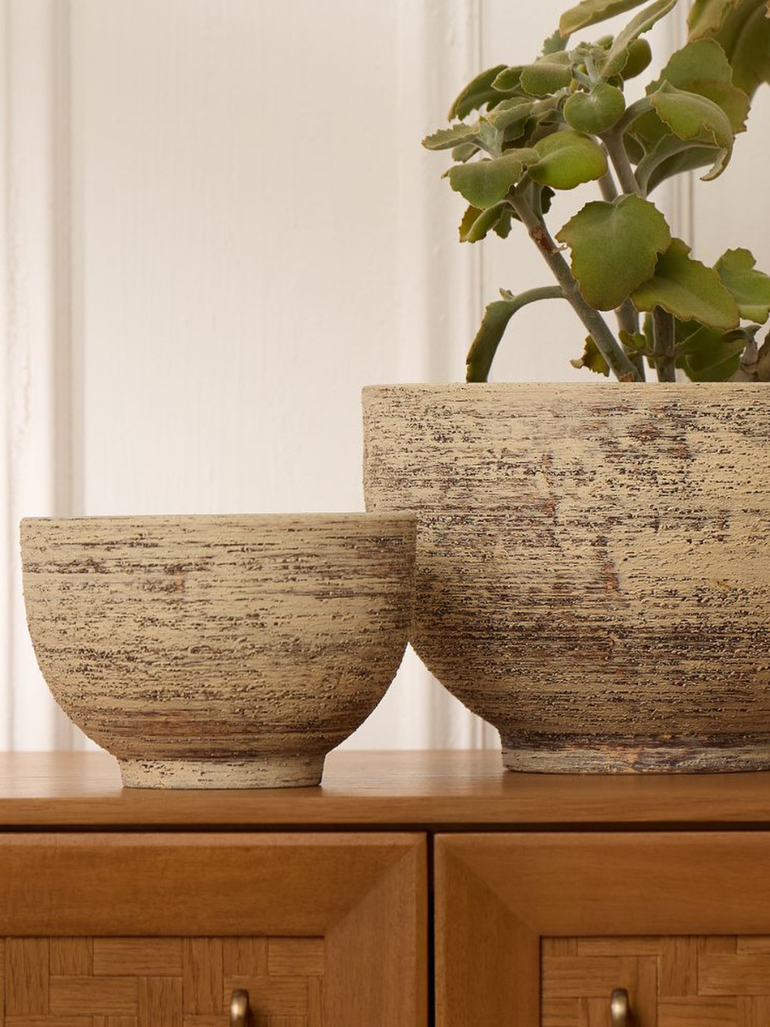A ceramic tabletop planter with an aged finish