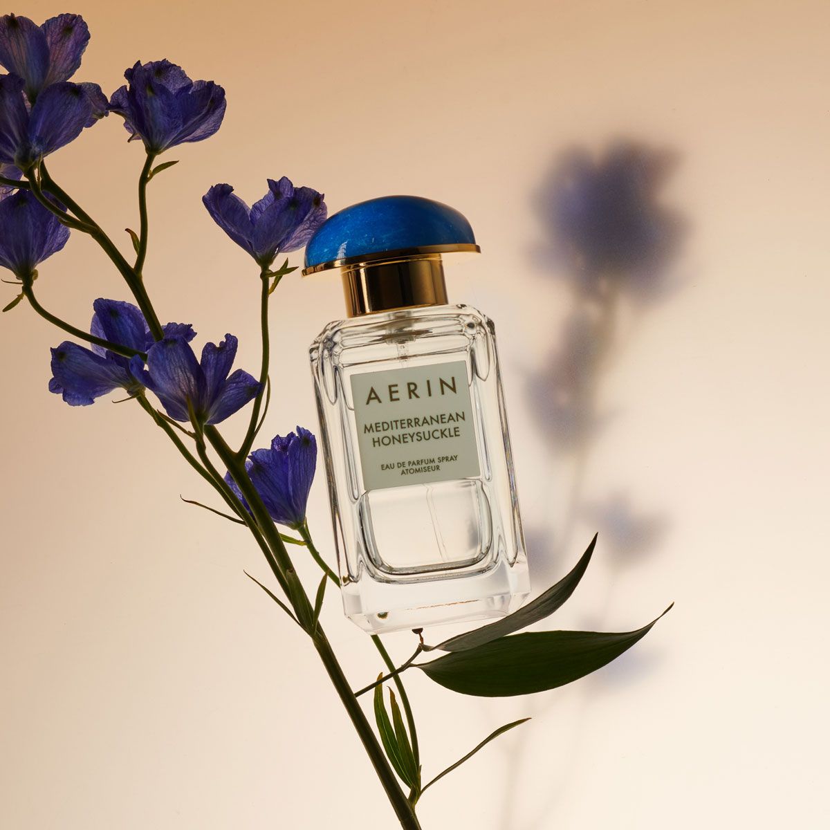 Aerin Mediterranean Honeysuckle Eau de Parfum floral perfume shot balanced on some flower leaves