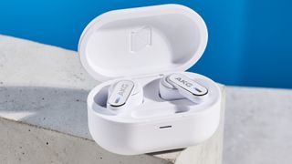 the akg n5 hybrid earbuds by harman in white, shown in their charging case with accessories and without