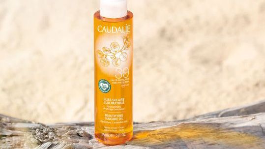 Best sun cream showing a bottle of Caudalie sun cream