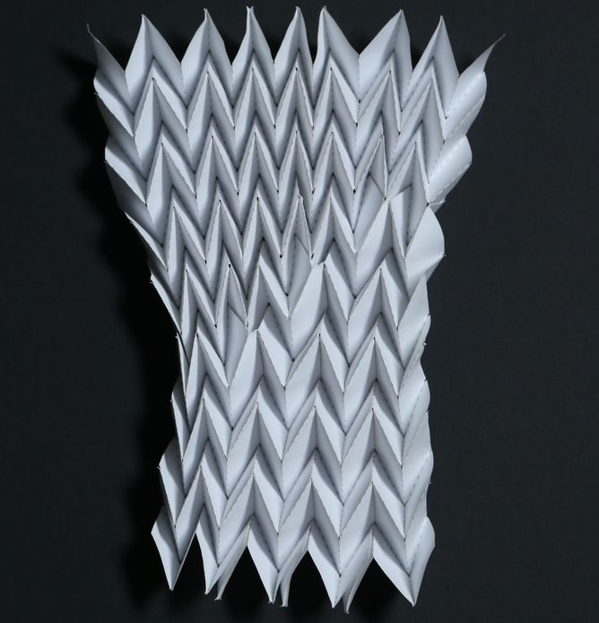 The Miura map fold with defects introduced. The defects lead to fewer pleats at the bottom than at the top.