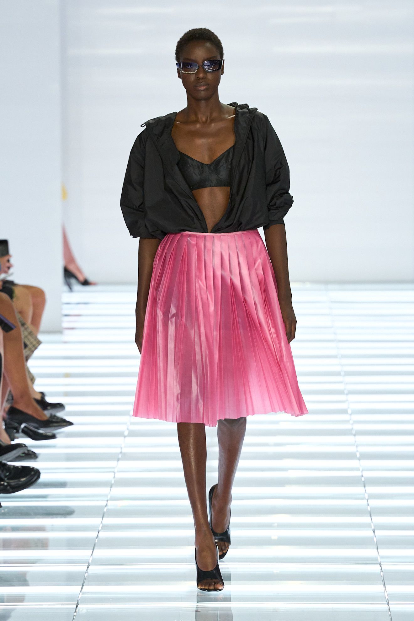 A model at the S/S 27 Prada show wearing a bralette and skirt.