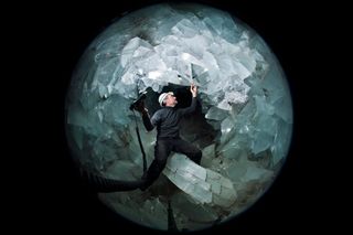 A researcher stands inside the crystal-filled cave known as the Pulpi Geode — the largest geode on Earth.