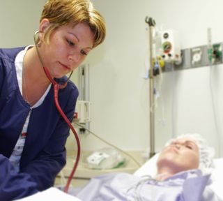 Callie Earliwine checks on a patient at Ohio Valley Medical Center in West Virginia where she works as a critical care nurse. Earliwine recently suffered a minor stroke while at work, and though there were plenty of warning signs, she didn't recognize the risks or symptoms. That's a common problem among women, according to a new national survey released by The Ohio State University Wexner Medical Center.