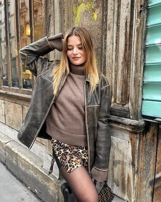 french woman wearing brown leather jacket outfit